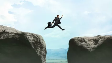 Man leaping chasm